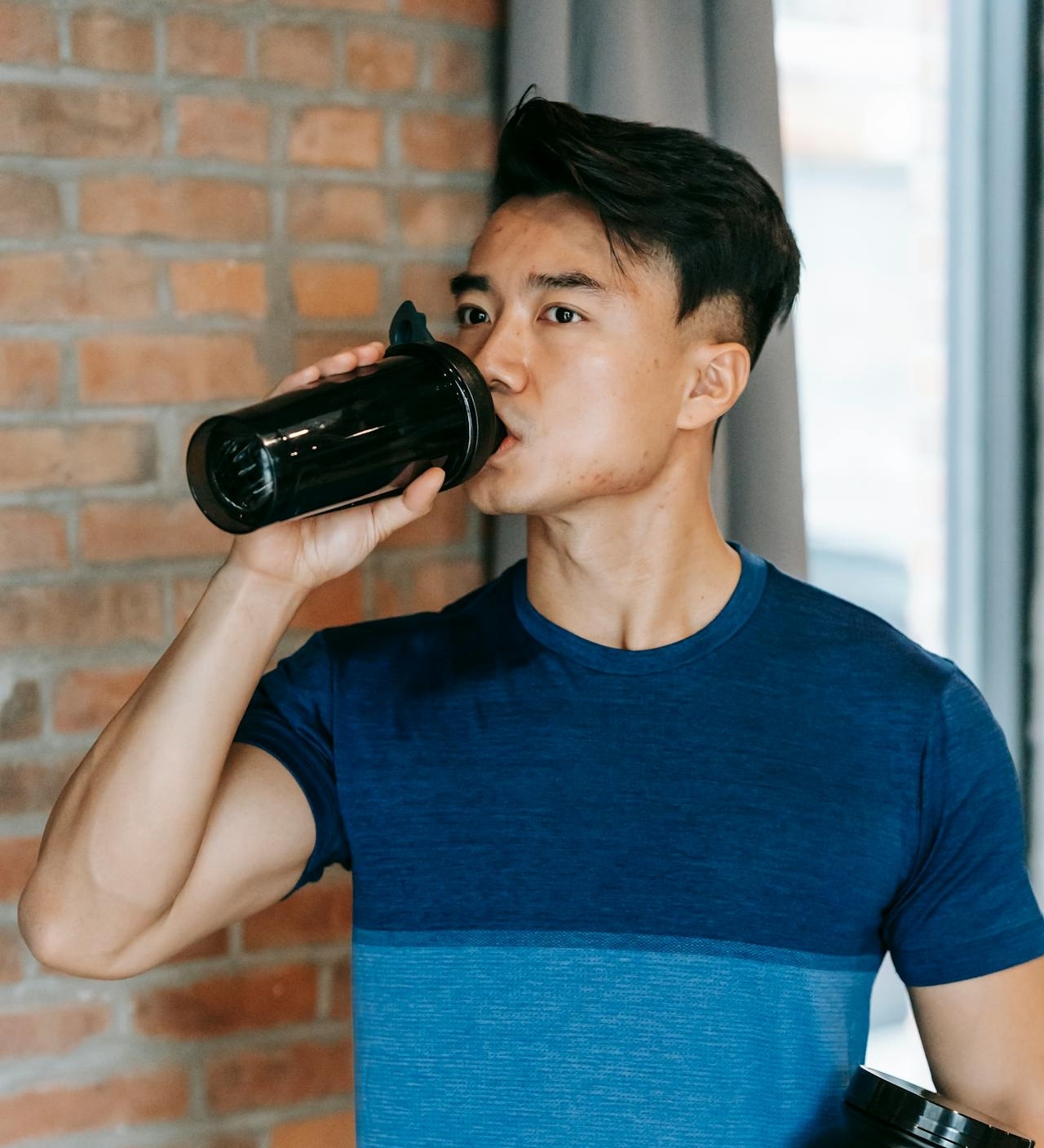 man drinking protein drink